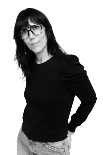 Shauna Griffiths wearing glasses and a black top in a professional portrait for her media features and credentials section.