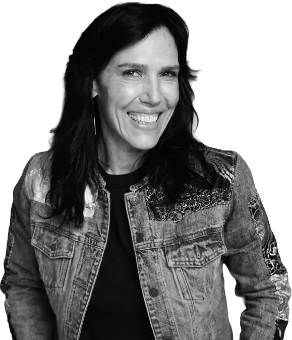 Shauna Griffiths looking at the camera in a custom denim jacket portrait for the intro services section.